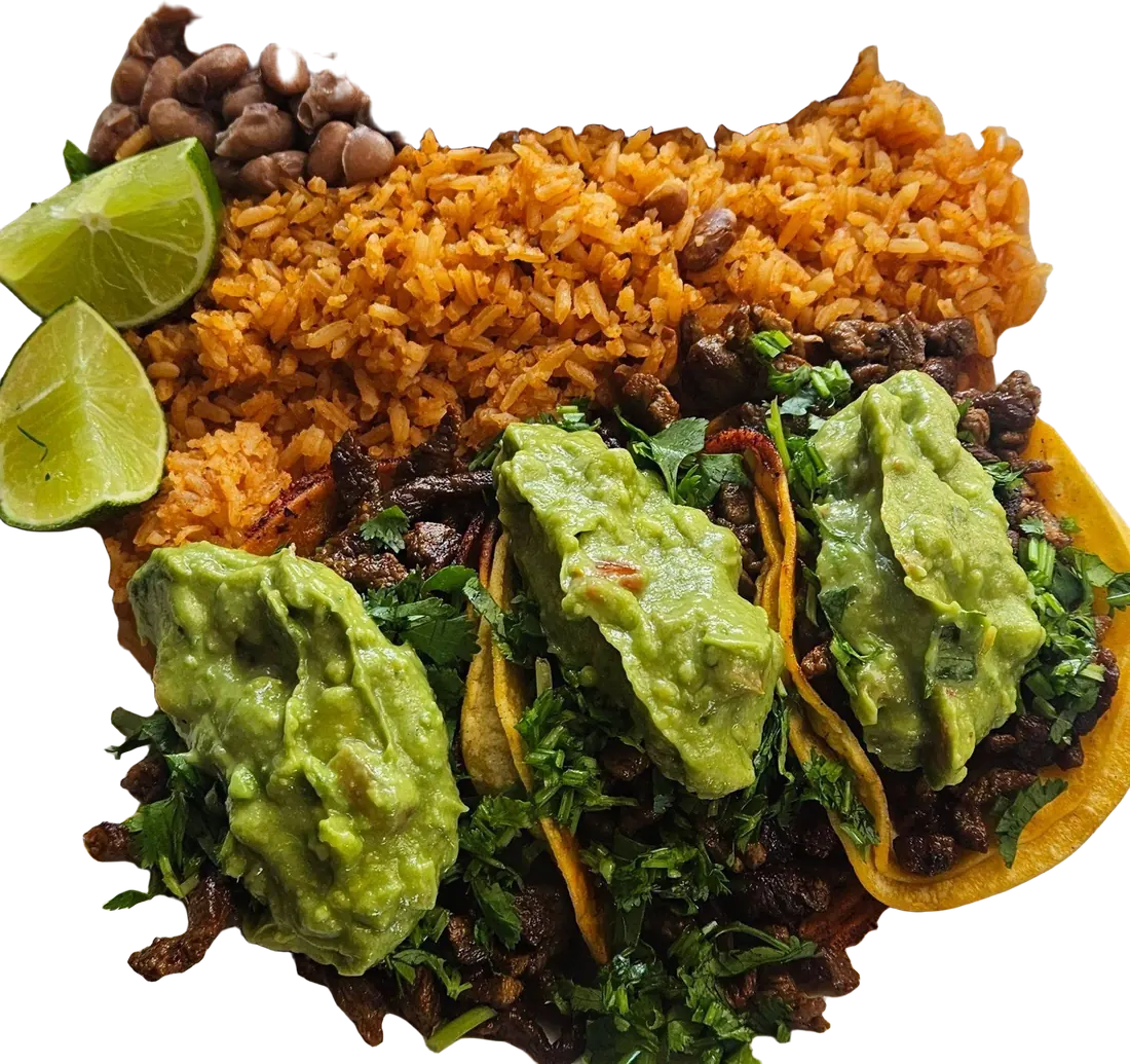 Three carne asada street tacos topped with guacamole and cilantro, with rice, beans and lime