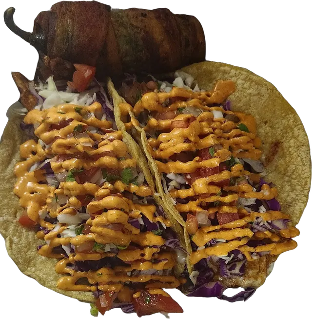 Two tacos with cabbage, pico and a chipotle cream drizzle