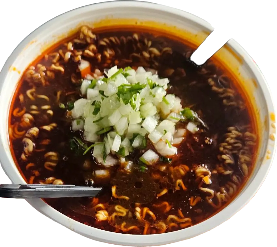 A bowl of birria ramen: noodles in dark red consommé, topped with diced onion and cilantro, a lime wedge beside it